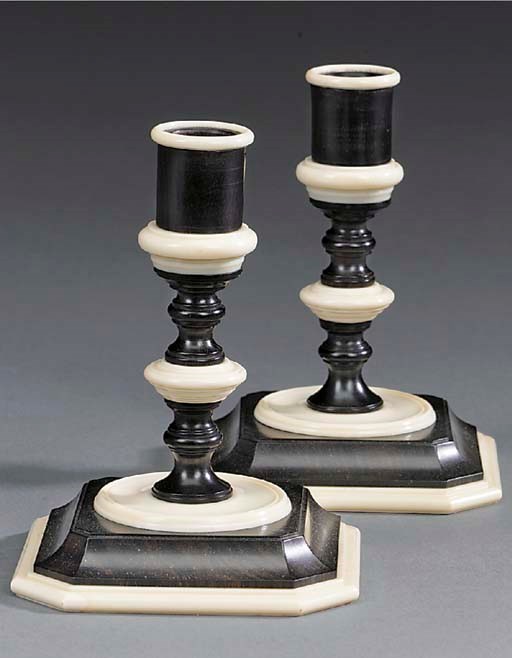A pair of ebony and ivory candlesticks, possibly early 20th century