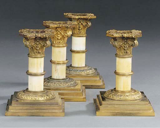 A set of four gilt brass and ivory candlesticks, circa 1890