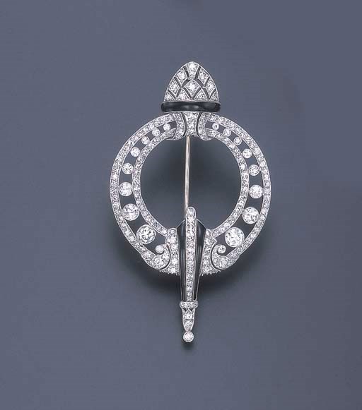AN ART DECO DIAMOND AND BLACK ENAMEL CIRCLE BROOCH