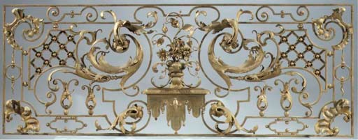 A gilded wrought-iron pierced overdoor panel