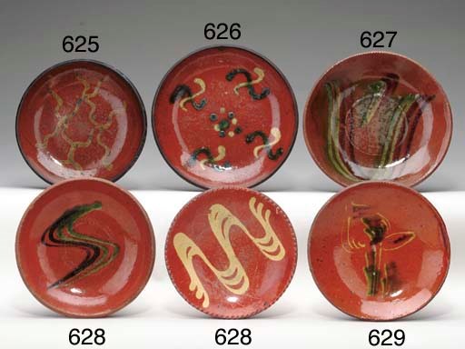 A SLIP-DECORATED REDWARE PLATE