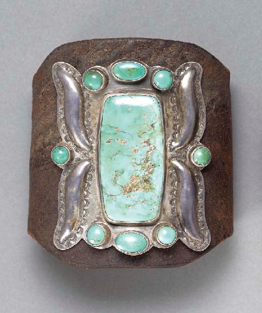 A NAVAJO SILVER AND TURQUOISE BOW GUARD