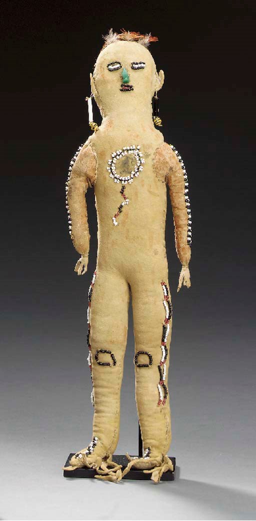 AN APACHE BEADED HIDE MALE DOLL