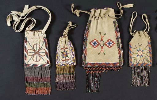 A GROUP OF FOUR APACHE BEADED HIDE POUCHES