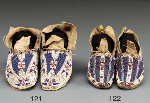A PAIR OF SOUTHERN ARAPAHO BEADED HIDE MOCCASINS