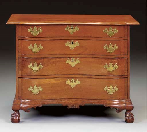 A CHIPPENDALE MAHOGANY REVERSE-SERPENTINE CHEST-OF-DRAWERS