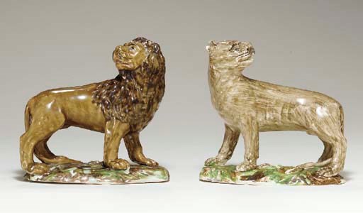 A PAIR OF STAFFORDSHIRE PEARLWARE  MODELS OF A LION AND LIONESS
