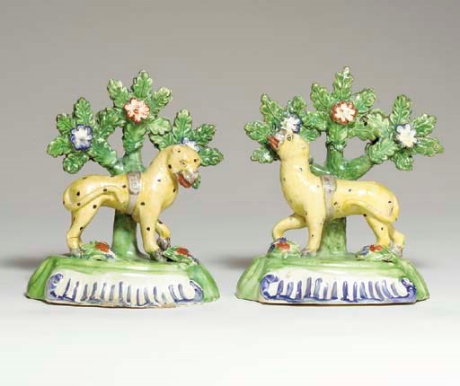 A PAIR OF STAFFORDSHIRE CREAMWARE MODELS OF LEOPARDS