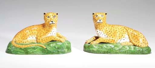 A PAIR OF STAFFORDSHIRE CREAMWARE MODELS OF LEOPARDS