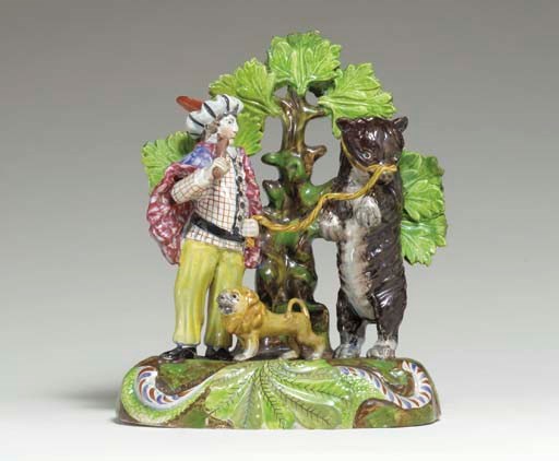 A STAFFORDSHIRE PEARLWARE GROUP OF A PERFORMING BEAR