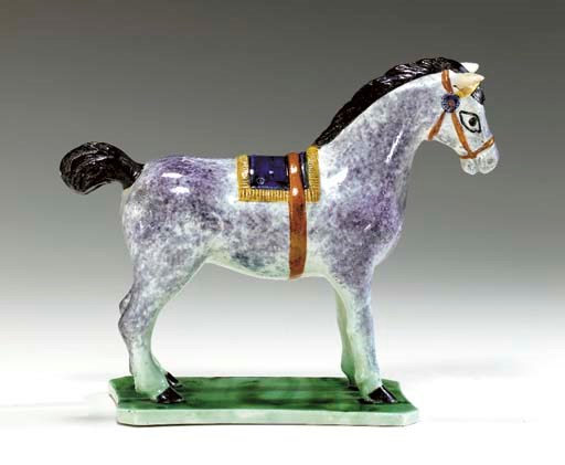 A STAFFORDSHIRE PEARLWARE MODEL OF A HORSE