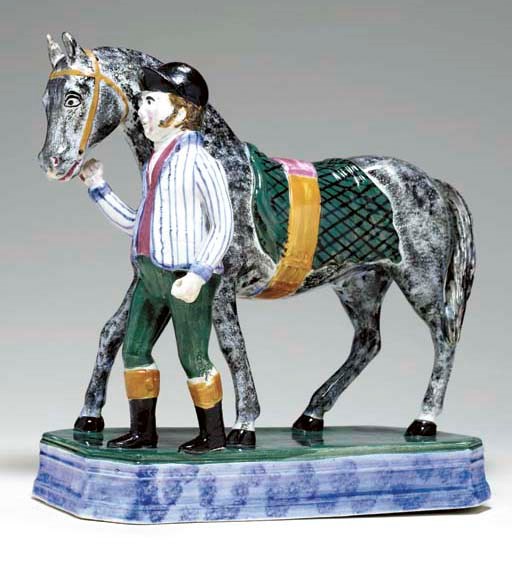 A BRITISH PEARLWARE MODEL OF A RACE HORSE AND JOCKEY