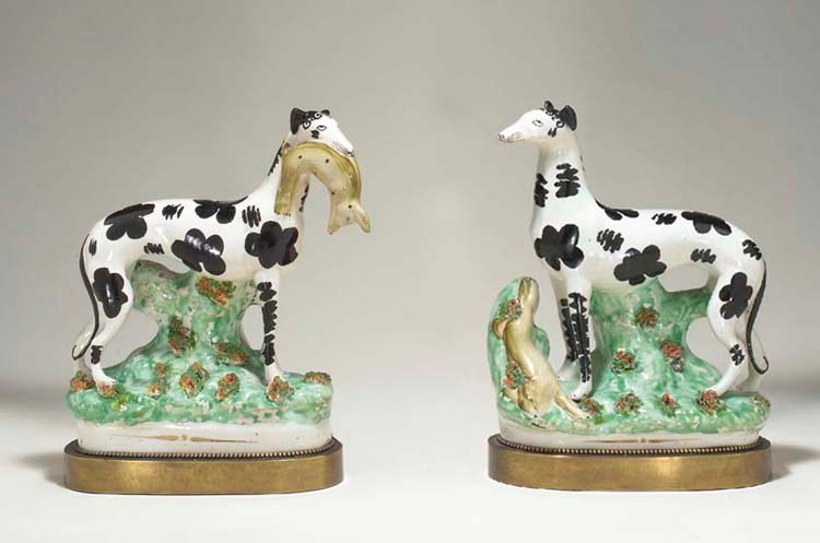 A PAIR OF STAFFORDSHIRE MODELS OF SPOTTED WHIPPETS