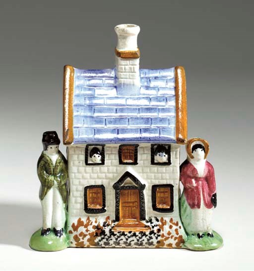 A STAFFORDSHIRE PEARLWARE MONEY-BOX