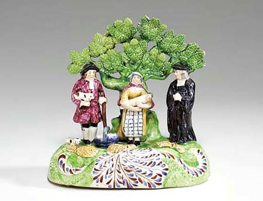 A STAFFORDSHIRE PEARLWARE 'TITHE PIG' GROUP
