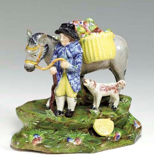 A STAFFORDSHIRE PEARLWARE FIGURE GROUP OF THE 'JOLLY TRAVELLER'