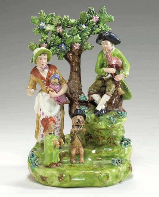 A STAFFORDSHIRE PEARLWARE FIGURE GROUP OF ITINERANT ENTERTAINERS