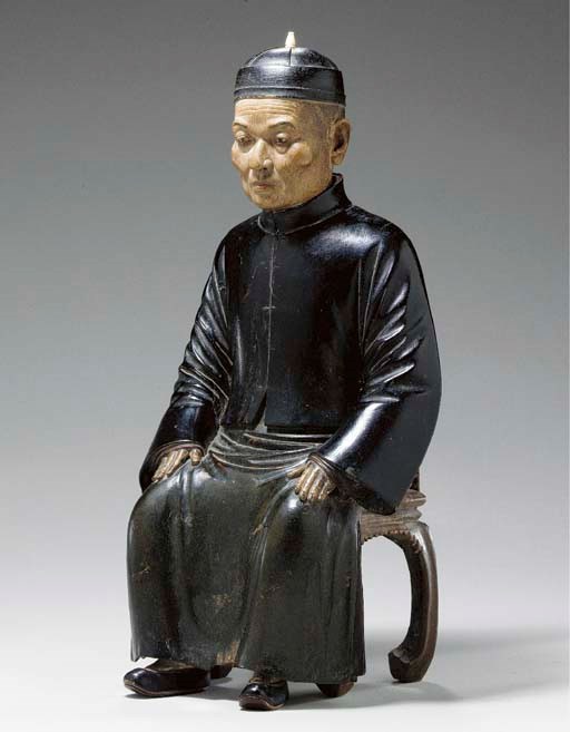 A CHINA TRADE FIGURE OF A SEATED MERCHANT