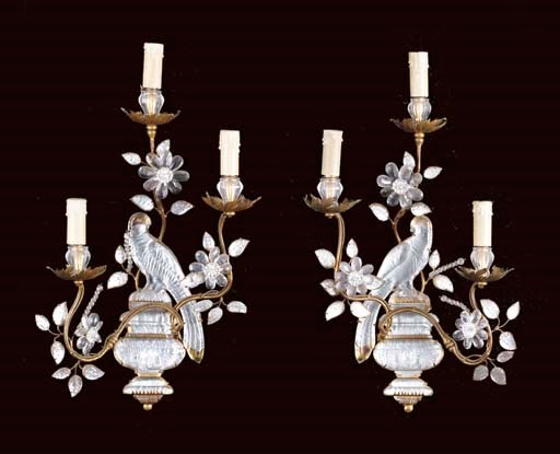 A pair of French giltmetal and moulded-glass three-light wall appliques,