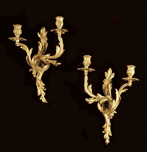 A pair of Louis XV style ormolu twin-light wall appliques,