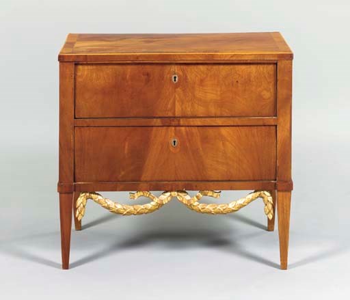 A NORTH EUROPEAN FRUITWOOD AND PARCEL-GILT COMMODE,