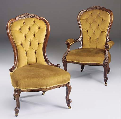 A Victorian walnut gentlemans open armchair and companion ladies chair