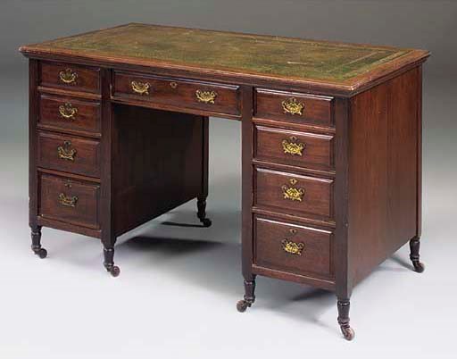 A late Victorian walnut kneehole desk