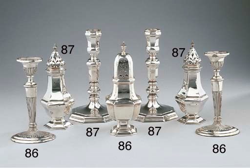 A pair of Dutch silver candlesticks and two English casters