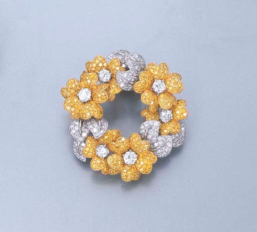 A YELLOW DIAMOND AND DIAMOND FLORAL BROOCH, BY GRAFF