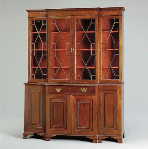 A GEORGE III STYLE MAHOGANY BREAKFRONT-BOOKCASE,