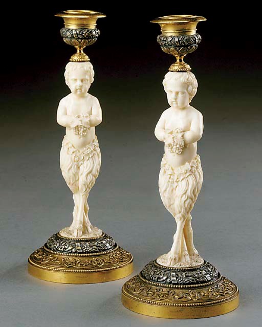 A pair of English carved-ivory, gilt- and silvered-bronze candlesticks