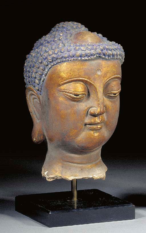 A CHINESE GILT AND LACQUERED STUCCO HEAD OF BUDDHA
MING DYNASTY