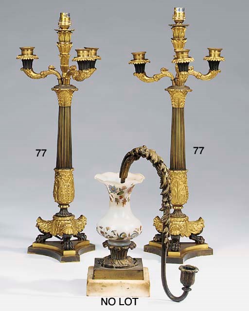 A pair of French gilt and patinated bronze four light candelabra