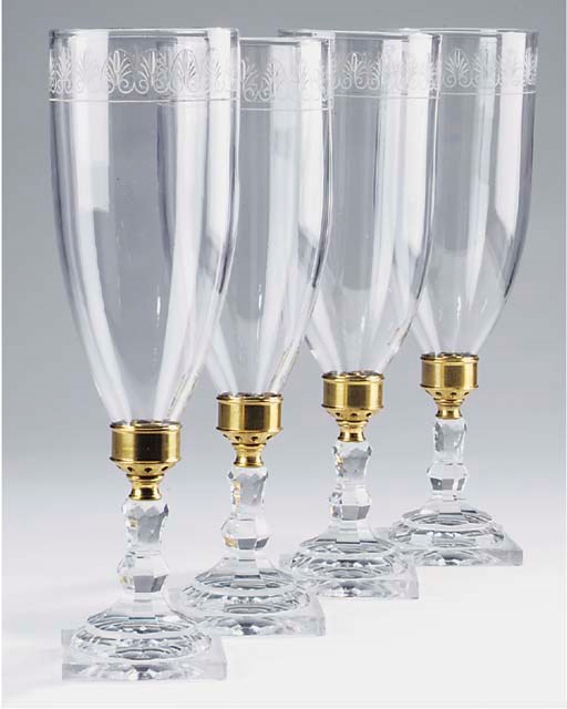 A set of four cut glass candlesticks with storm shades, 20th century