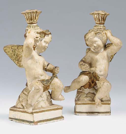 A pair of Continental terracotta figural candlesticks, late 19th century
