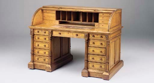 A MID-VICTORIAN OAK ROLL TOP DESK