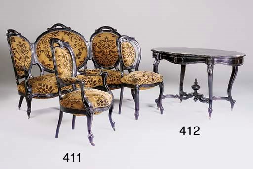 A Napoleon III ebonized serpentine centre table