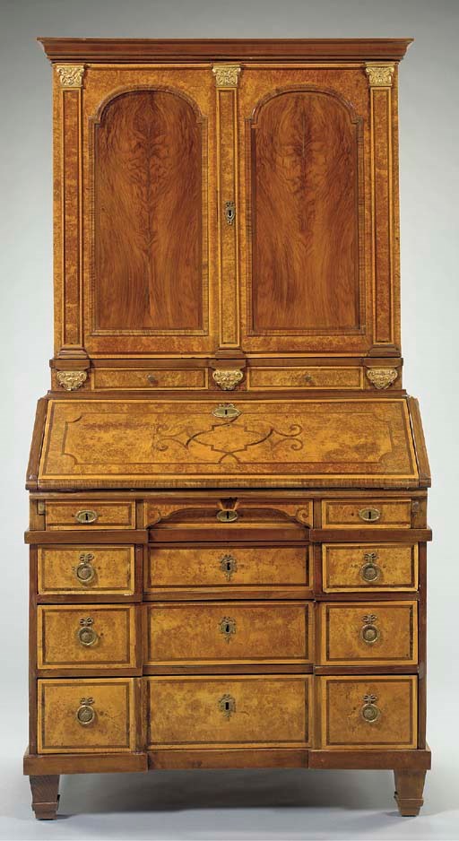 A GERMAN NEOCLASSIC BURL ELM WALNUT AND PARCEL-GILT SECRETAIRE BOOKCASE,