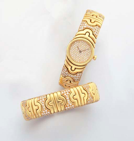 BULGARI. A LADY'S 18K GOLD AND DIAMOND-SET BANGLE-WATCH WITH A MATCHING BANGLE