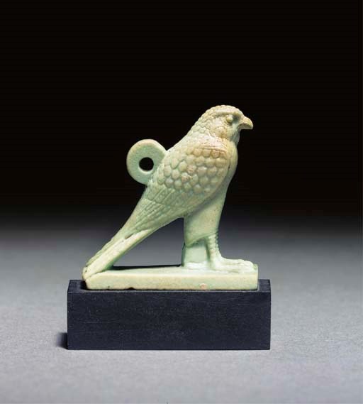 AN EGYPTIAN PALE GREEN GLAZED COMPOSITION AMULET OF HORUS