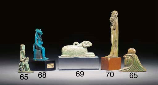 AN EGYPTIAN GREEN GLAZED COMPOSITION LION-HEADED AMULET