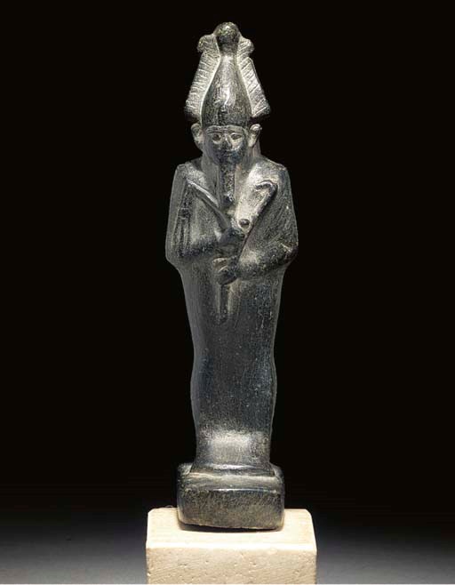AN EGYPTIAN BLACK STEATITE FIGURE OF OSIRIS