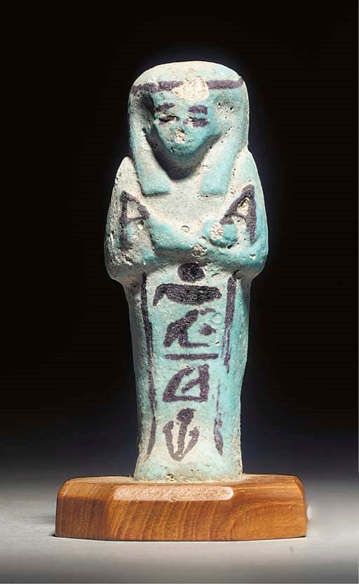 AN EGYPTIAN BLUE GLAZED COMPOSITION SHABTI, FOR MUT-EN-APT