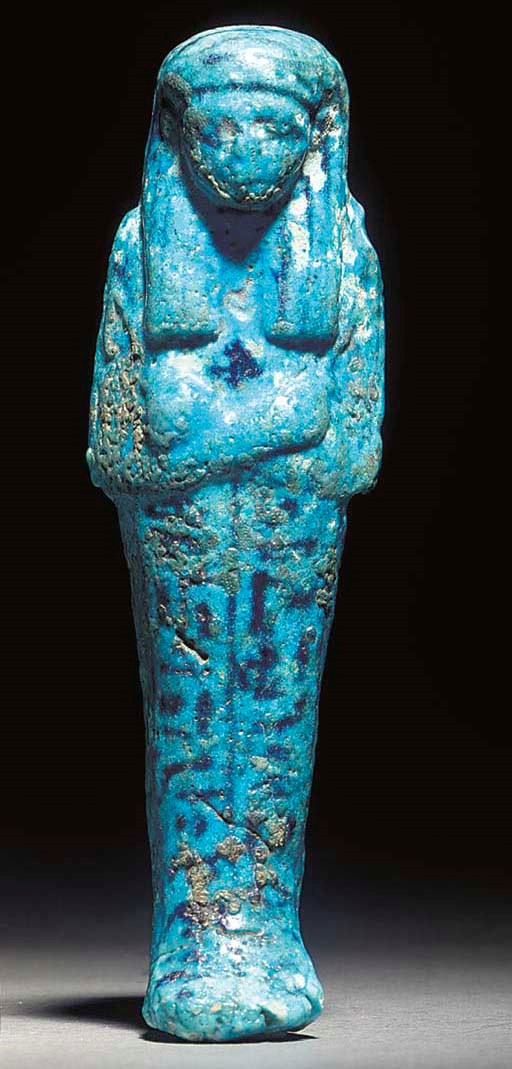 AN EGYPTIAN BRIGHT BLUE GLAZED COMPOSITION SHABTI FOR THE HIGH RANKING PRIEST AND OFFICIAL NESYPERNUB