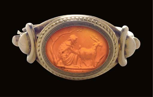 A ROMAN CORNELIAN INTAGLIO WITH GOATHERD MILKING GOAT