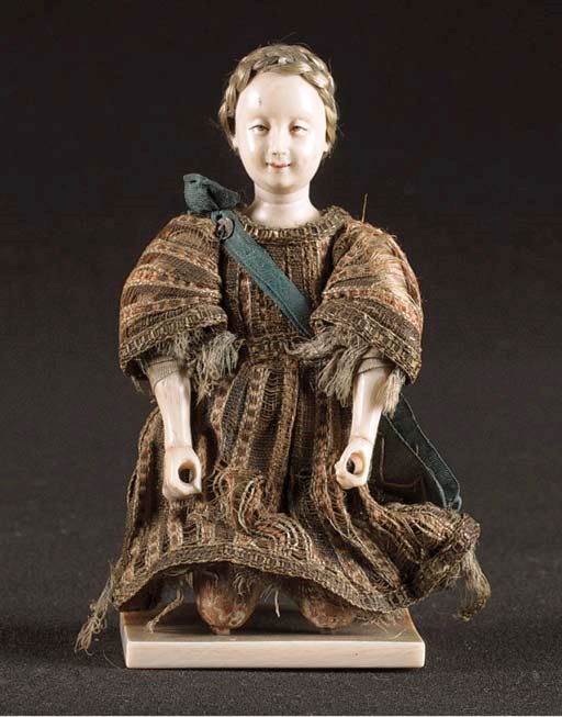 A fine ivory carving of a kneeling smiling European woman