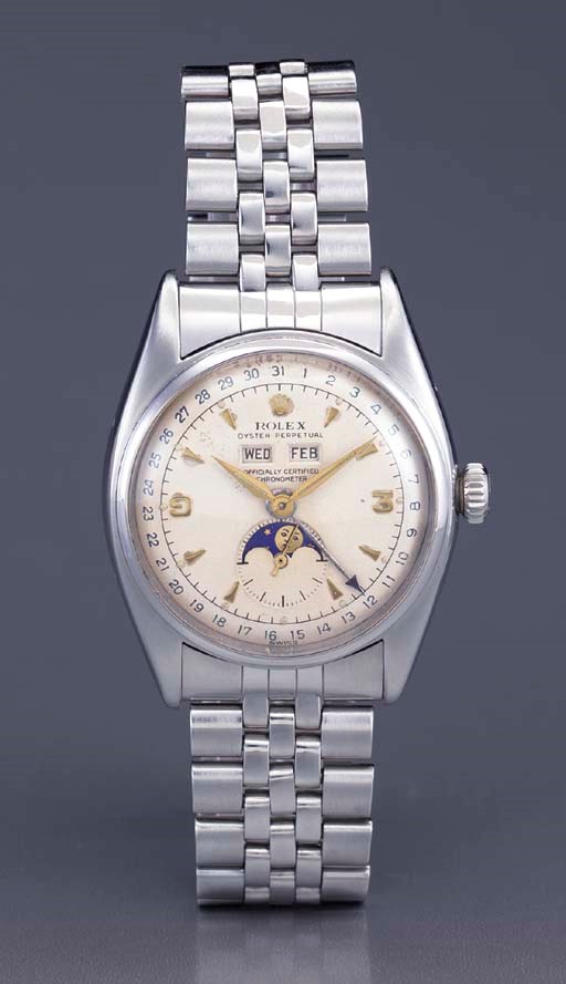 Rolex. A fine and rare stainless steel self-winding water-resistant triple calendar wristwatch with phases of the moon and bracelet