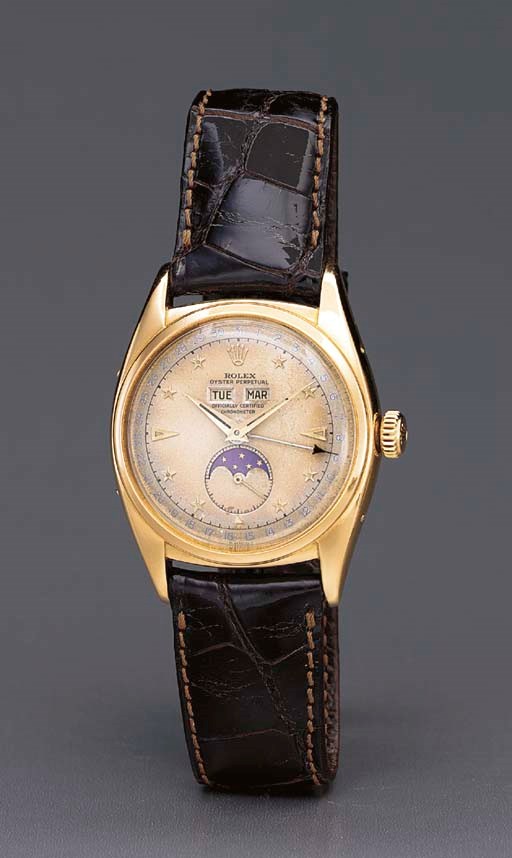 Rolex. A fine and rare 18K gold self-winding water-resistant triple calendar wristwatch with phases of the moon and two-tone star dial