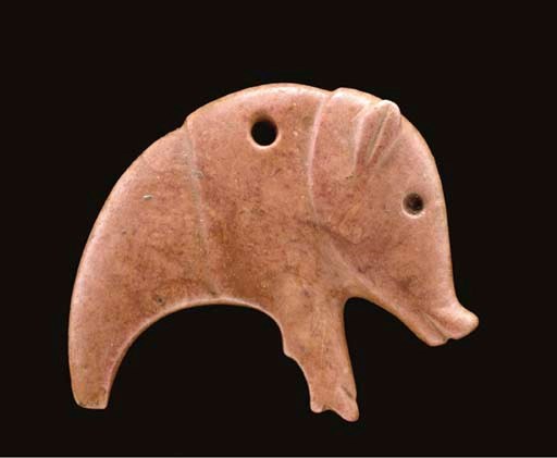 A SYRIAN RED MARBLE AMULET