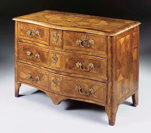 A LOUIS XV PROVINCIAL ORMOLU-MOUNTED WALNUT, AMBOYNA AND FRUITWOOD COMMODE